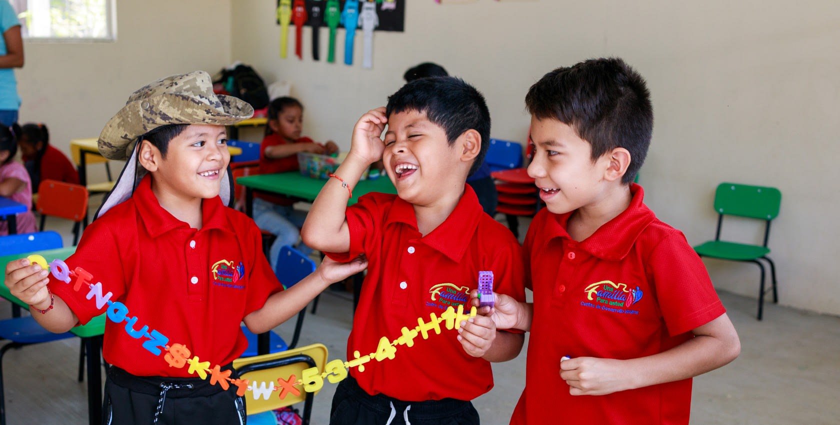 3 children boys in a children ministry classroom playing happily.