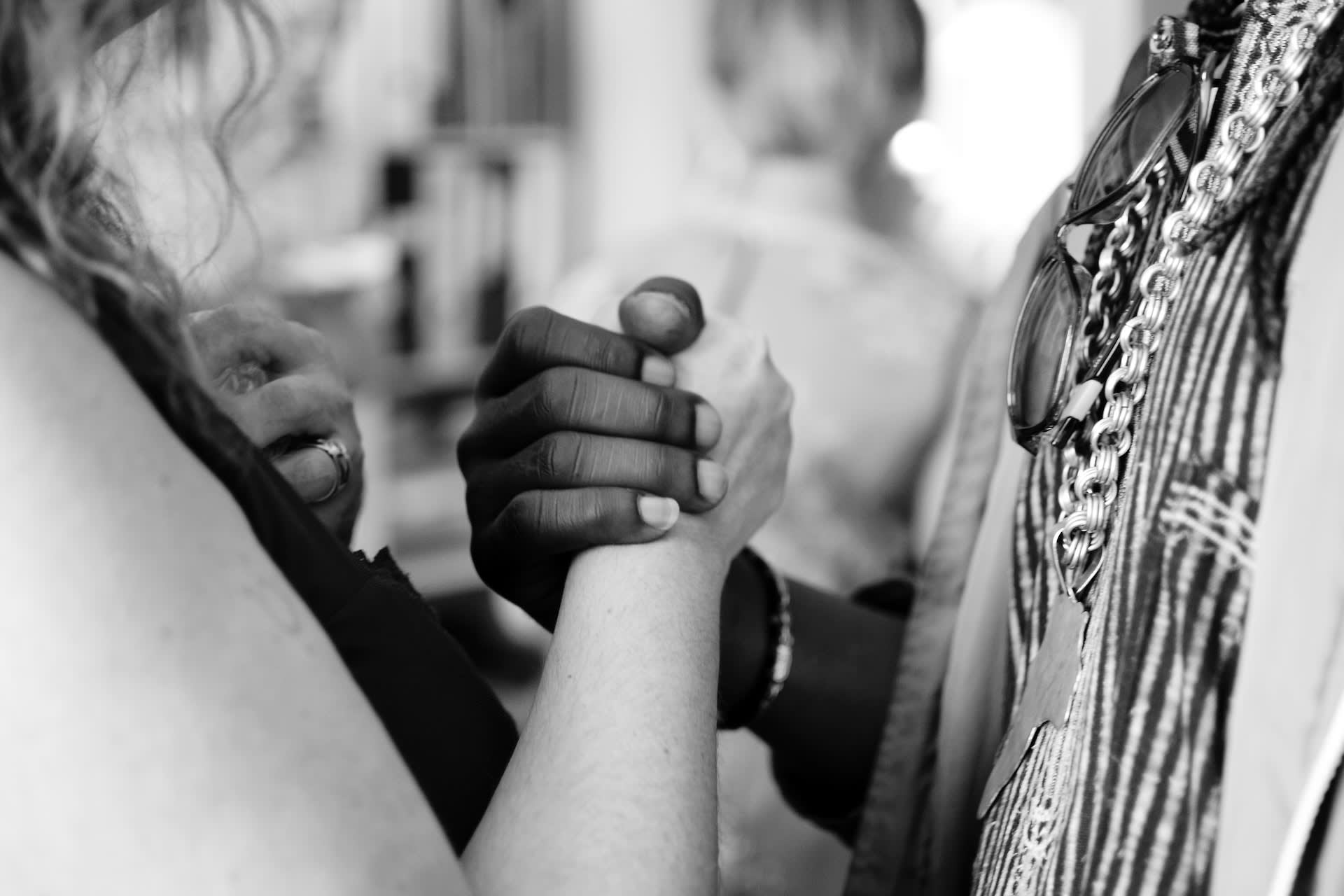 Two individuals holding hands.