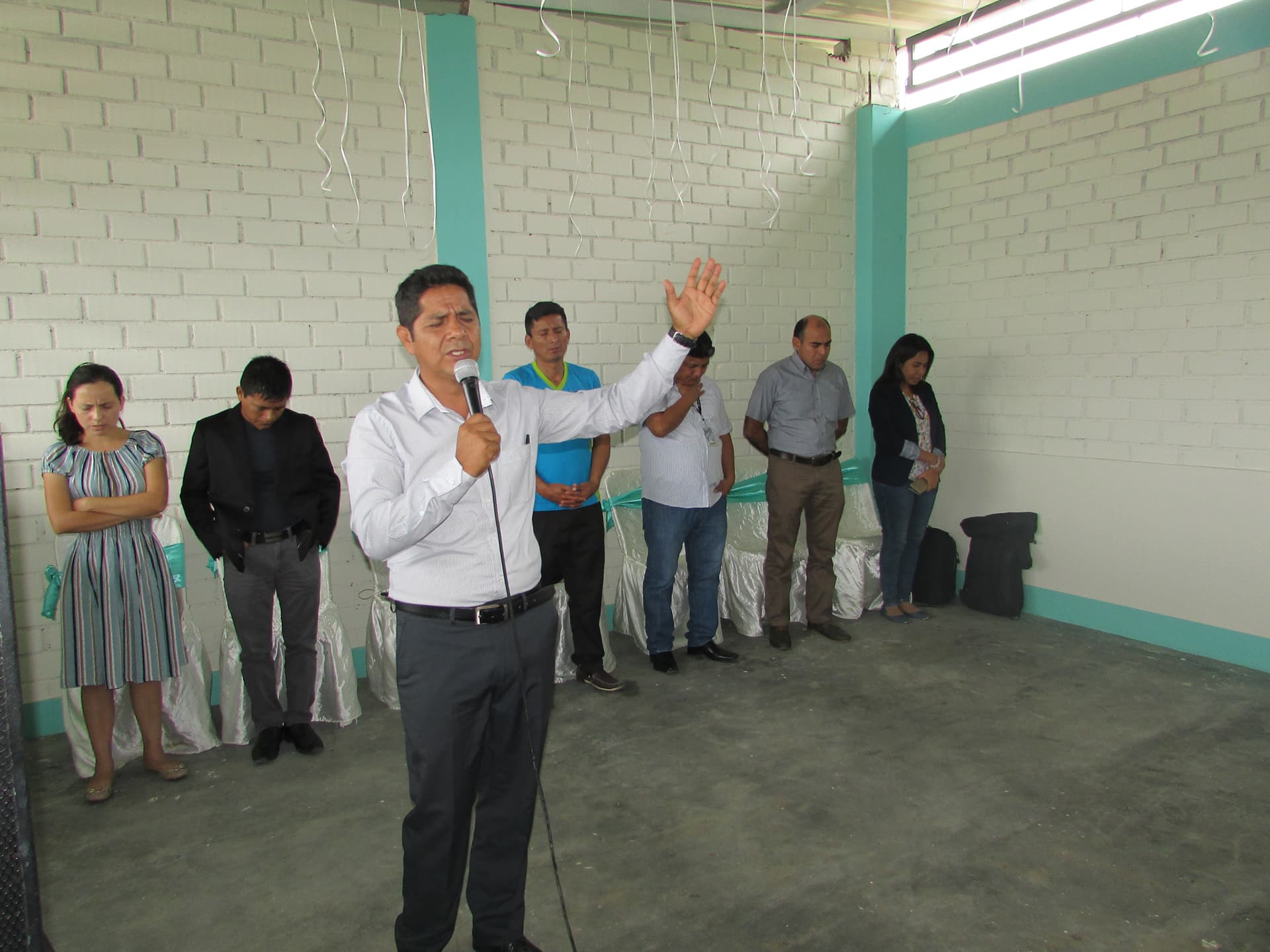 A pastor preaches at the front of the church