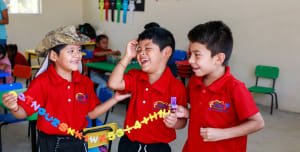 3 children boys in a children ministry classroom playing happily.