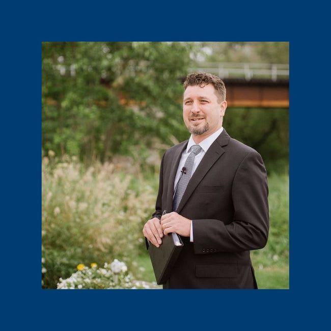 Pastor Gary holding a Bible and wearing a suit