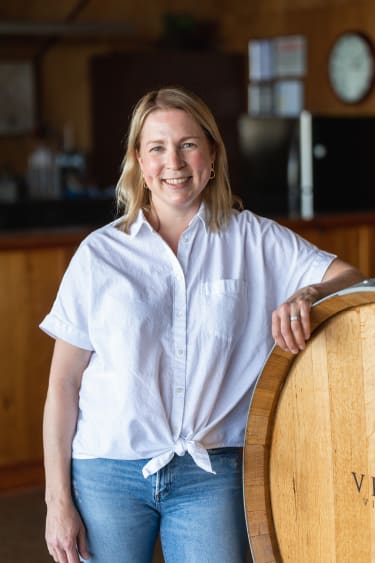 Erin Allen is inside the boutique tasting room, she enjoys the philanthropic nature of our community and small winery.