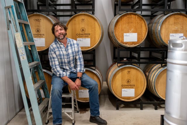 Owner Dru Allen inside the authentic barrel room of the production space at Compris Vineyard, a green winery.