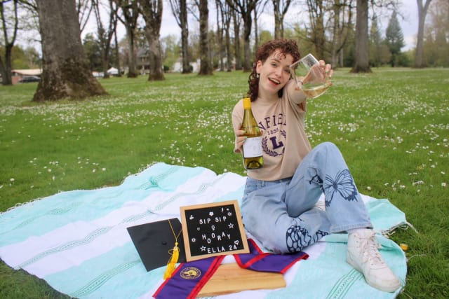 Ella Burgess of Compris Vineyard in a park after her graduation from Linfield University.