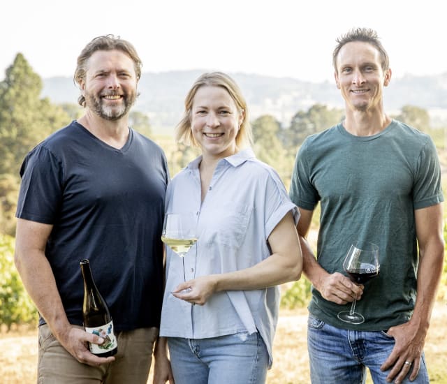 The small winery team of Aaron, Dru, and Erin in front of their vineyard located just outside of Newberg, Oregon.