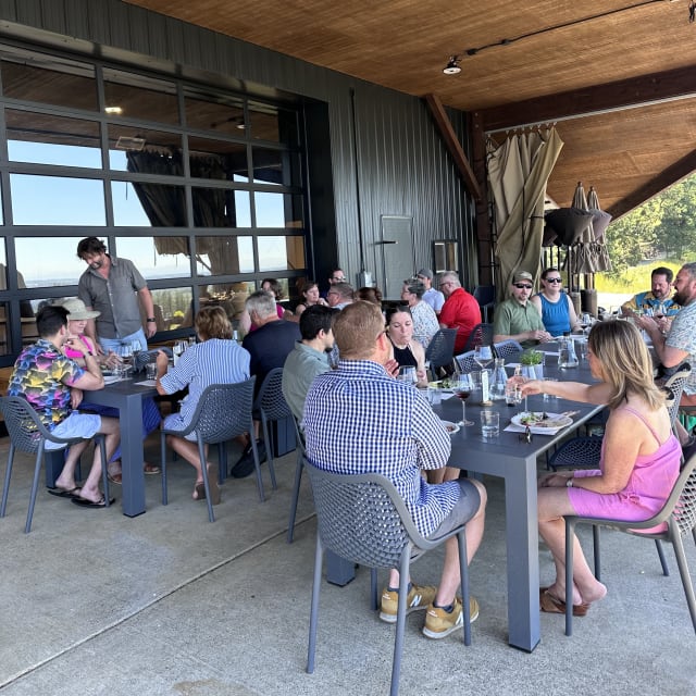 Anthology club members gathered on our tasting room patio for conversation and connection at Compris Vineyard.