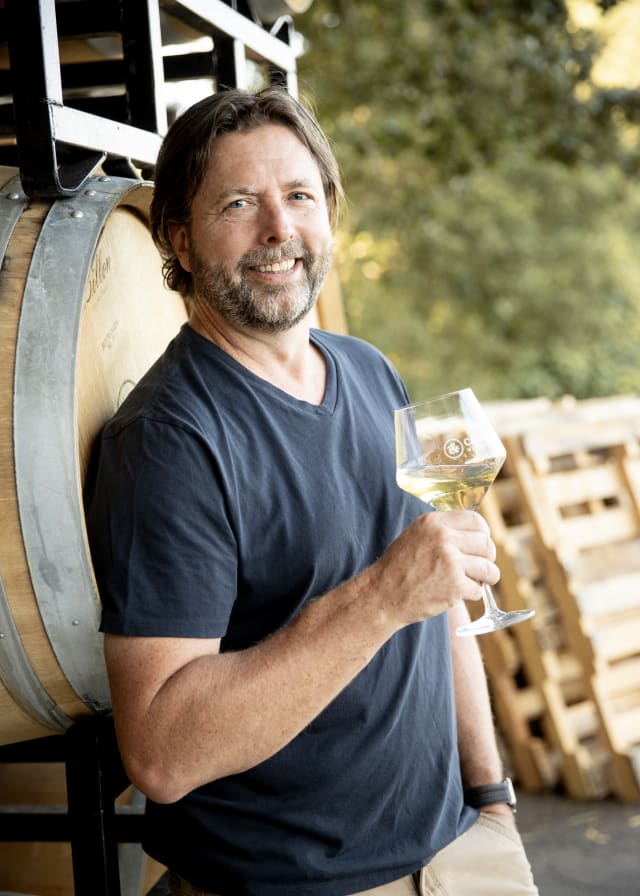 Owner Dru Allen outside the production space at Compris Vineyard, who enjoys making and sharing premium wines with our community.