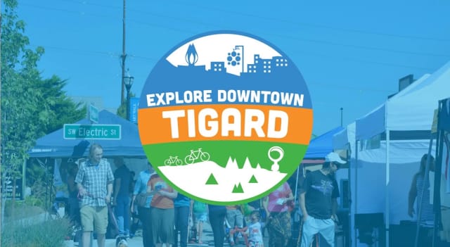 The logo of the Downtown Tigard Association with guests in the background.