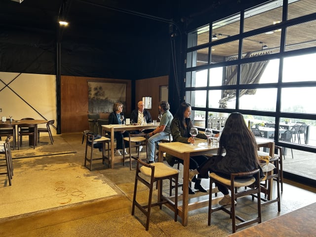 Slide Image. Guests inside the tasting room at Compris Vineyard, located in the Willamette Valley of beautiful Oregon.