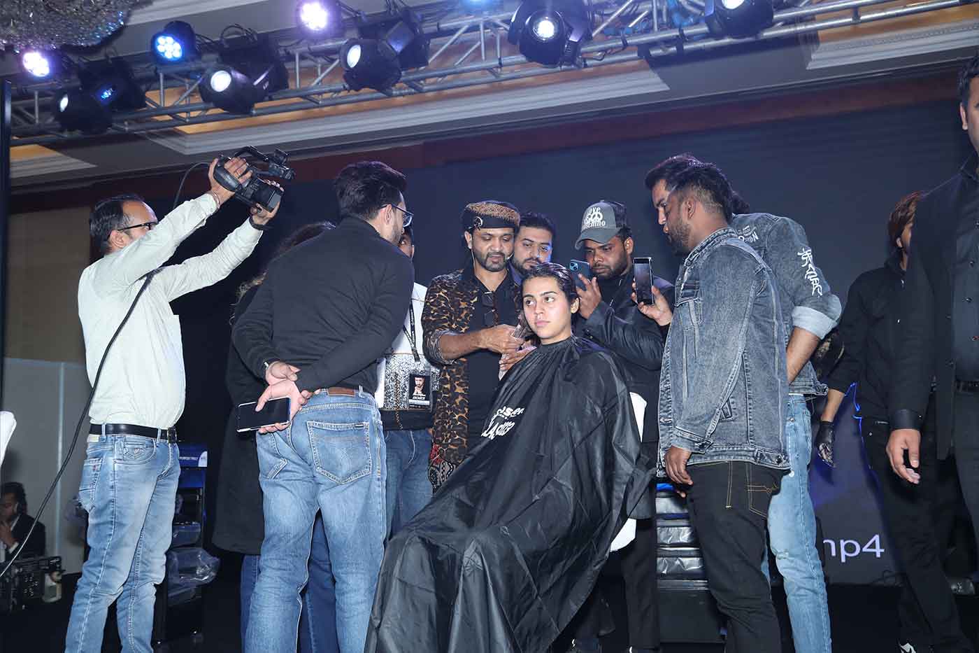 hairstylist naseem salmani demonstrating on the stage 