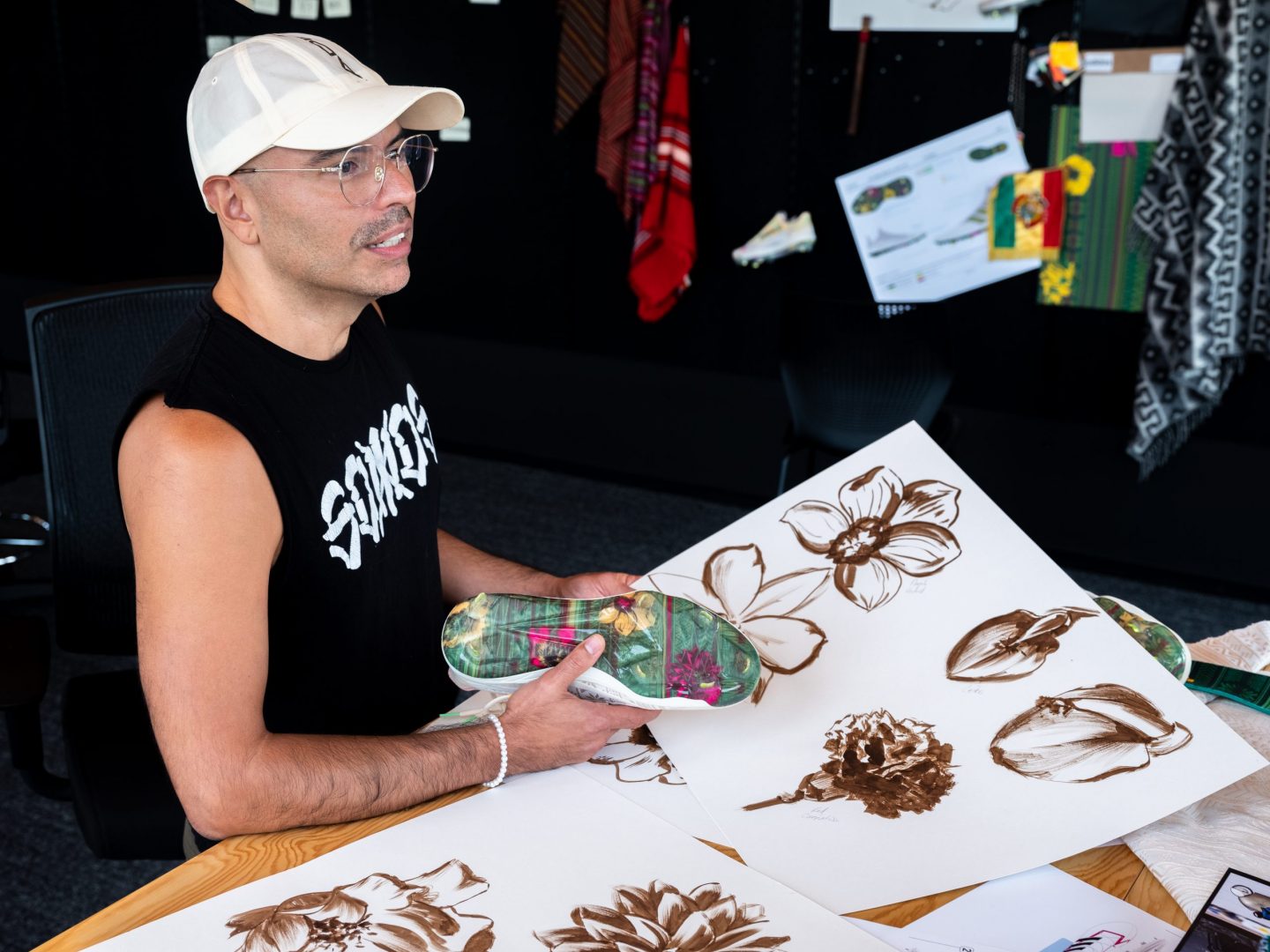 Designer Julio Aleman shows off the hand painted flowers used in the design.