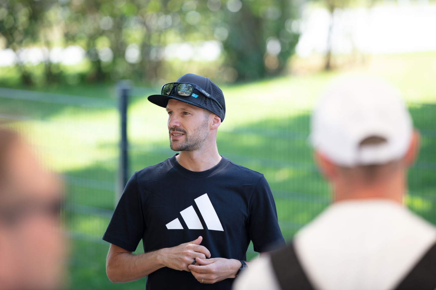 Patrick chats with adidas employees before giving them swimming tips in the campus pool.