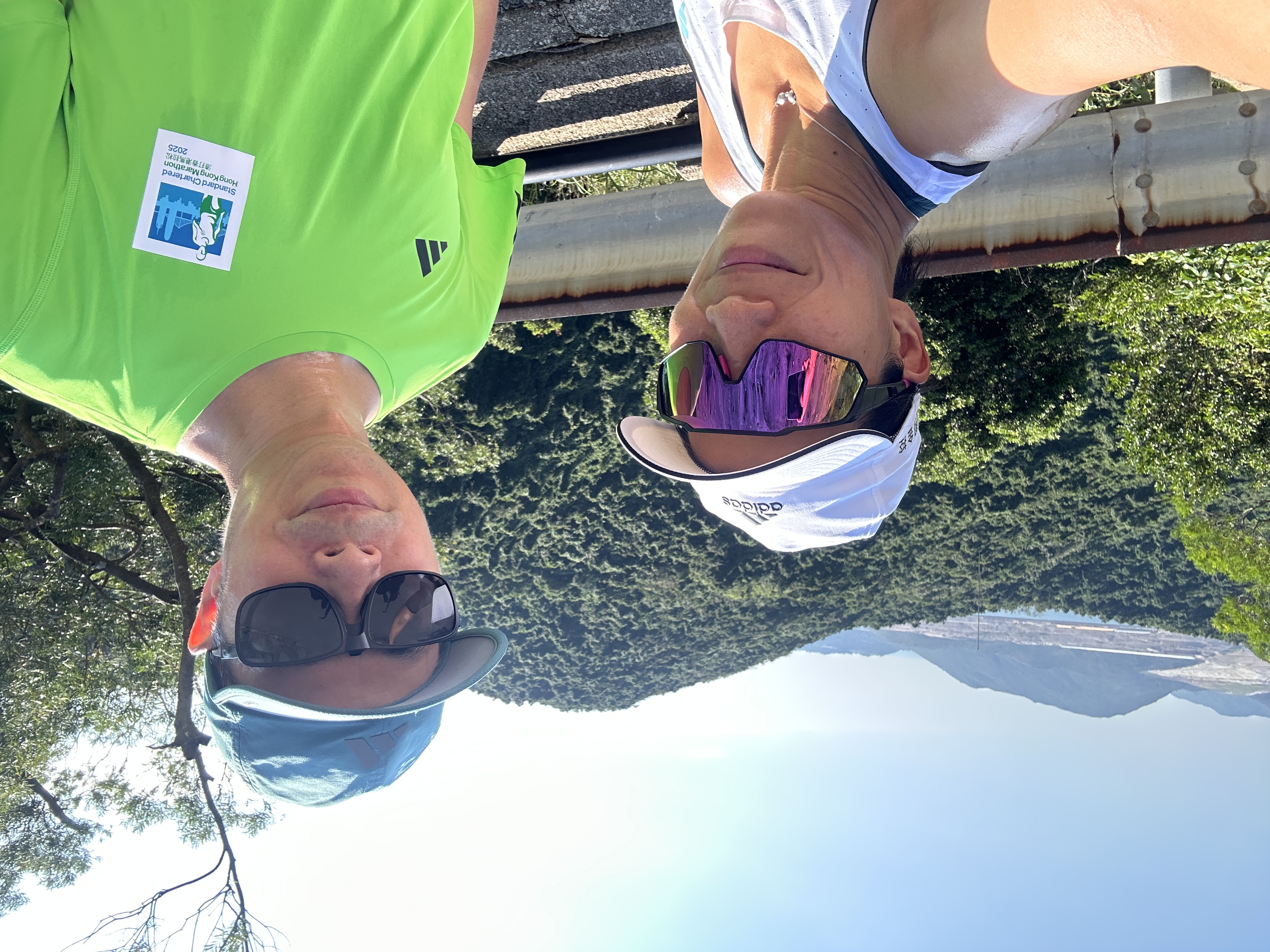 Woman and man take selfie of themselves overlooking tree-covered trees