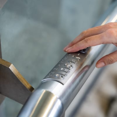 3D printed braille handrail signs with hand