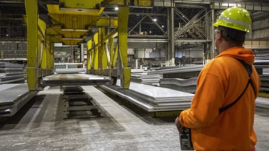 Operator moves stack of aluminium sheet