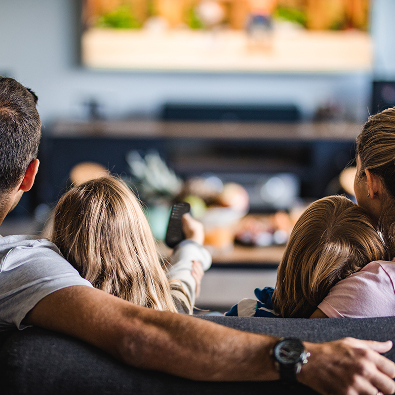 Family on couch watching tv