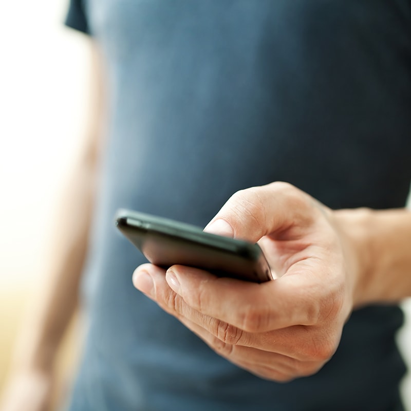 man interacting with his smartphone