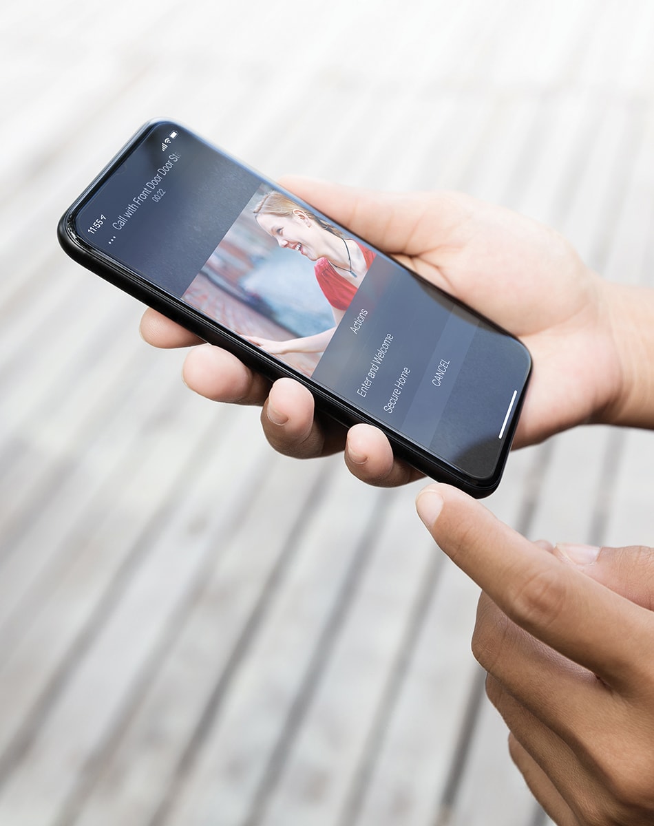 mobile phone with video feed of person in front doorbell