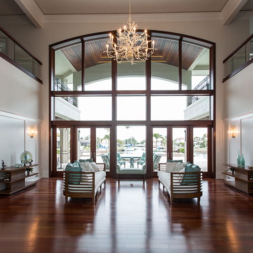 Inside of home with large glass windows peering into the backyard