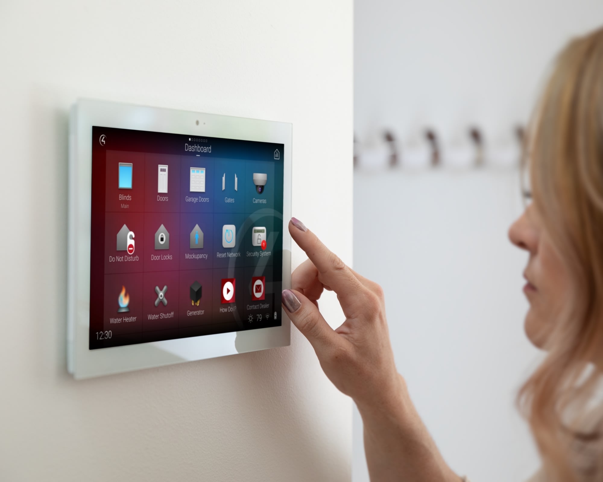 Woman interacting with Control4 smart home OS 3 on in-wall touch screen