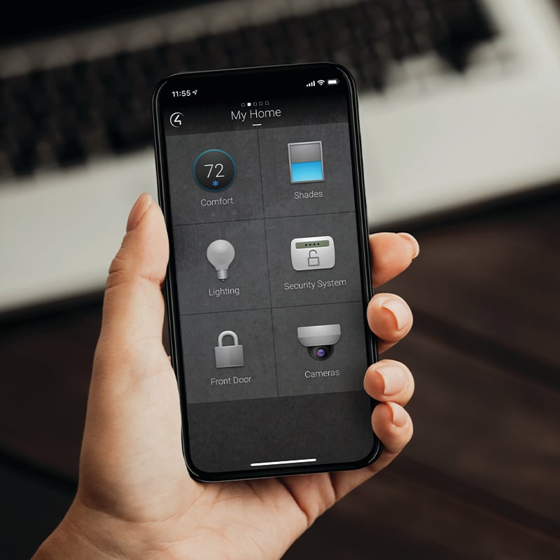 Person holding phone with Control4 home control app open