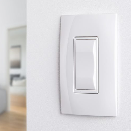 Sleek white light switch on wall