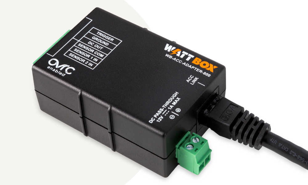 WattBox in rack with person's hand touching trigger