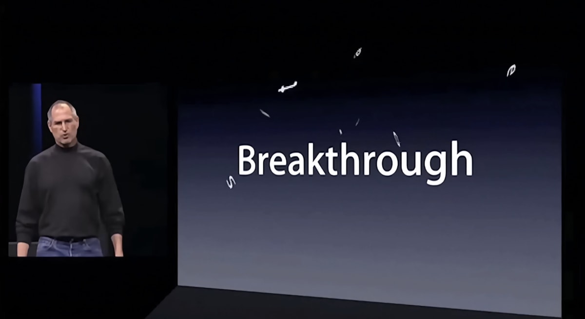Steve Jobs standing in silence beside a slide showing a single word: ’Breakthrough’.