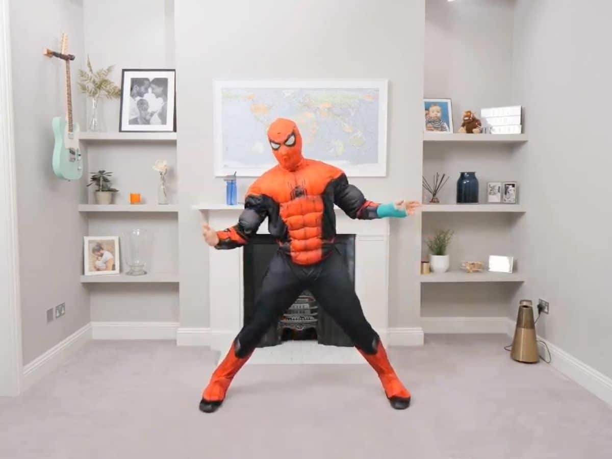 Fitness instructor Joe Wicks teaching a class from his home, dressed as Spider-Man.