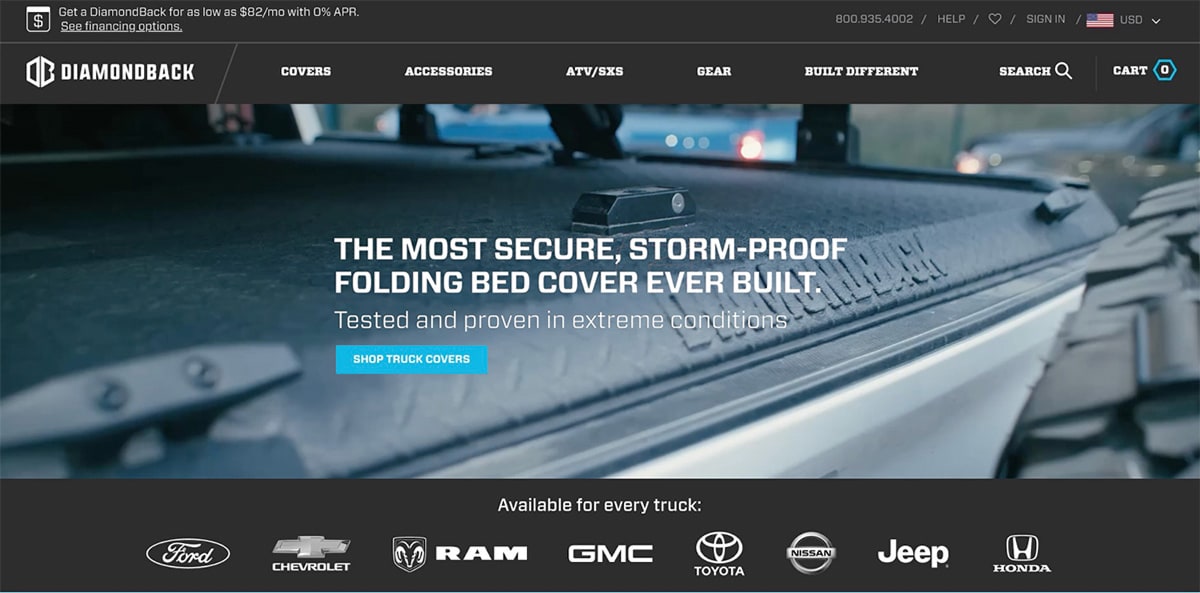 DiamondBack homepage hero variation featuring a close-up of a rugged truck bed cover with the headline &lsquo;The most secure, storm-proof folding bed cover ever built&rsquo; and the supporting line &lsquo;Tested and proven in extreme conditions&rsquo;, emphasizing security and durability.