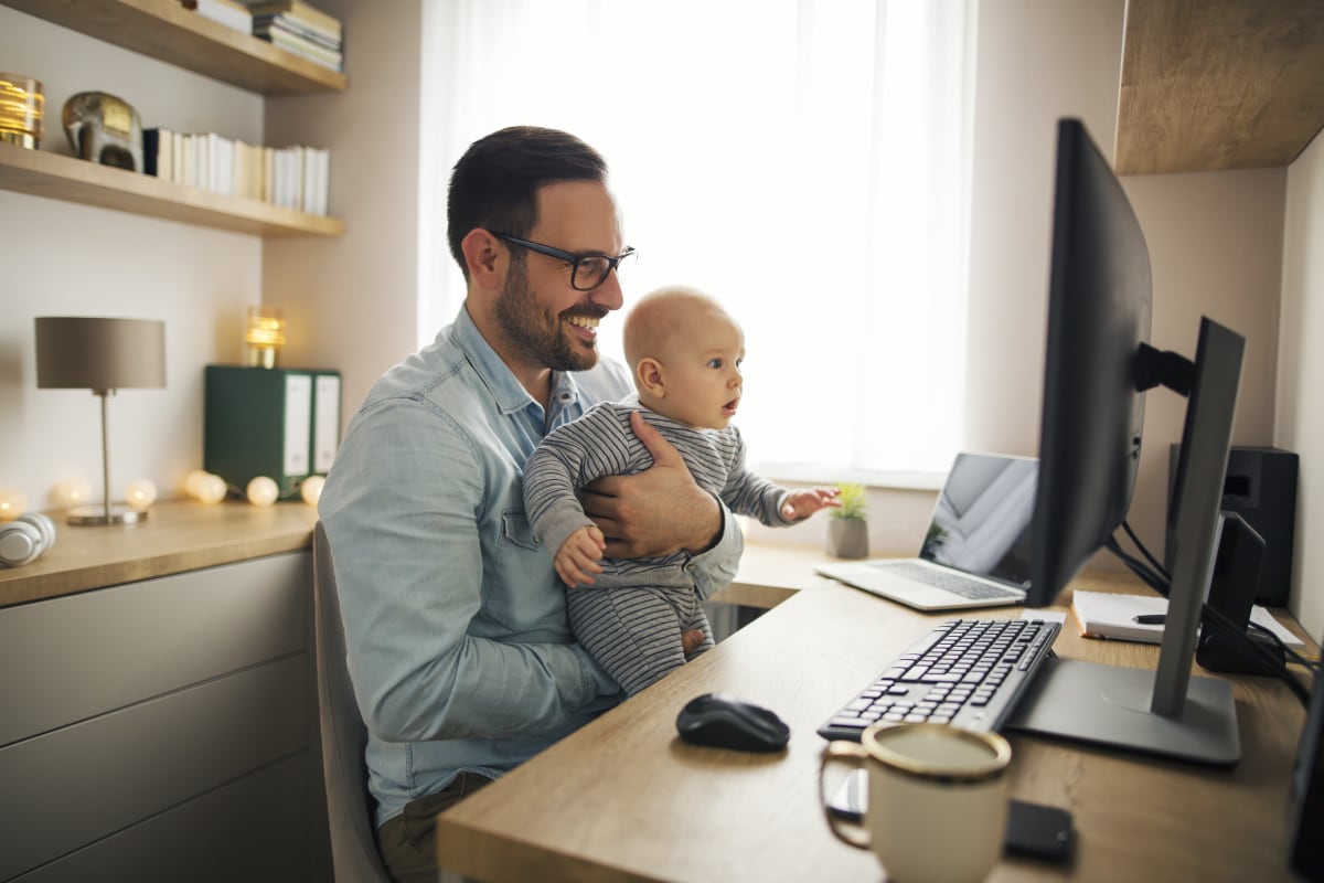 A father and son working in their home office.