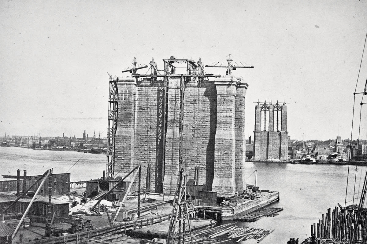 The Brooklyn Bridge under construction.