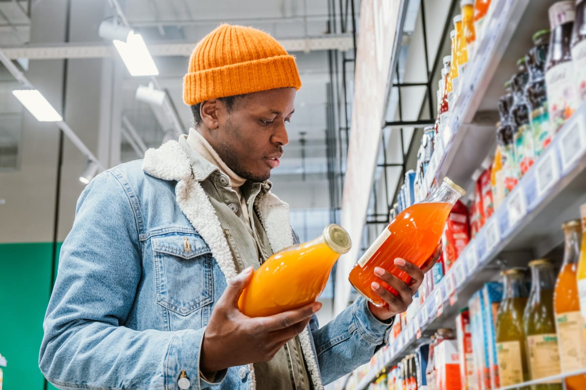 A person trying to choose between two different natural juices