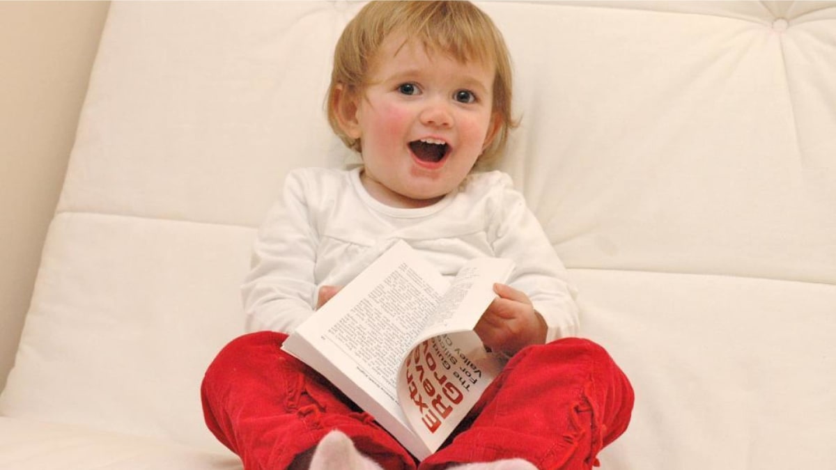 A photo of a child reading a book.