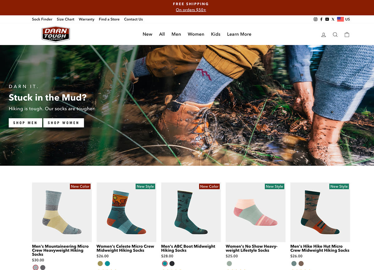 The Darn Tough homepage featuring hikers wearing socks in muddy terrain and showcasing various sock styles for men and women.