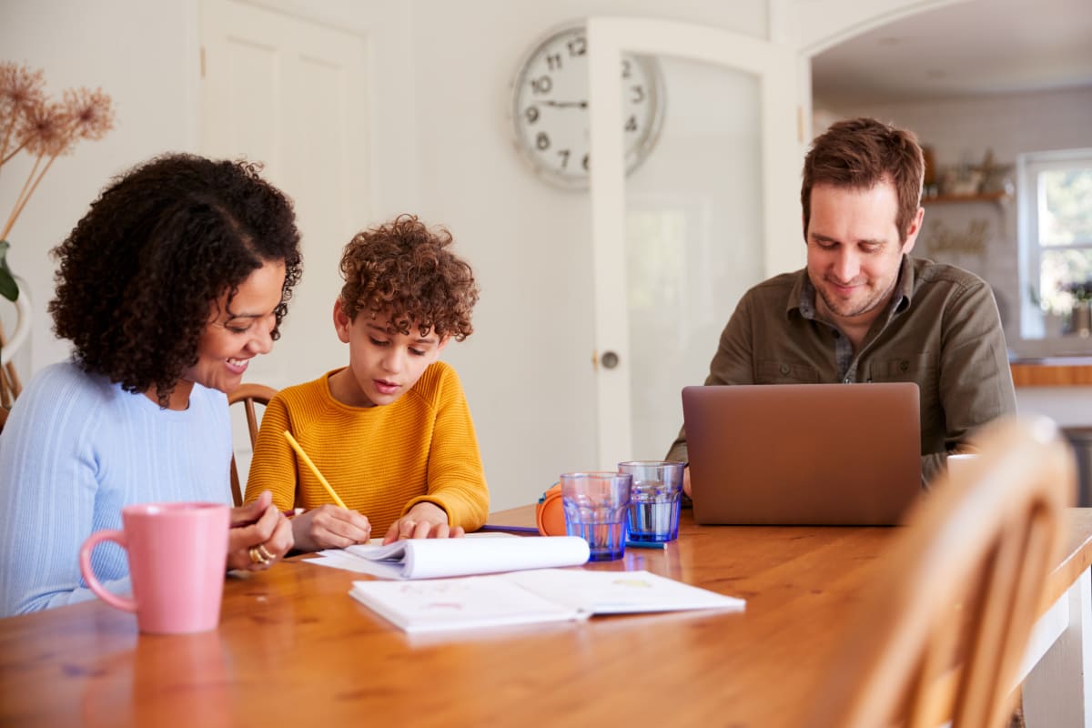 A family working at the dining table.