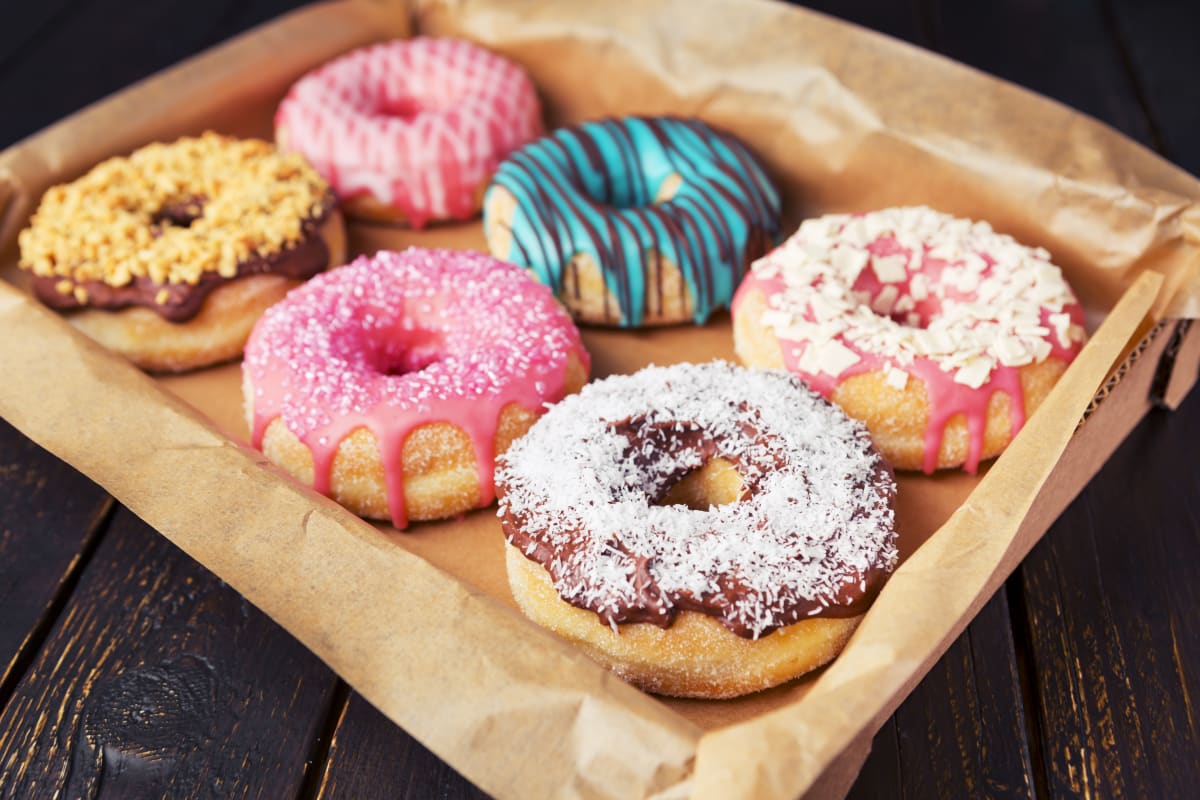 A box of very fancy iced donuts.