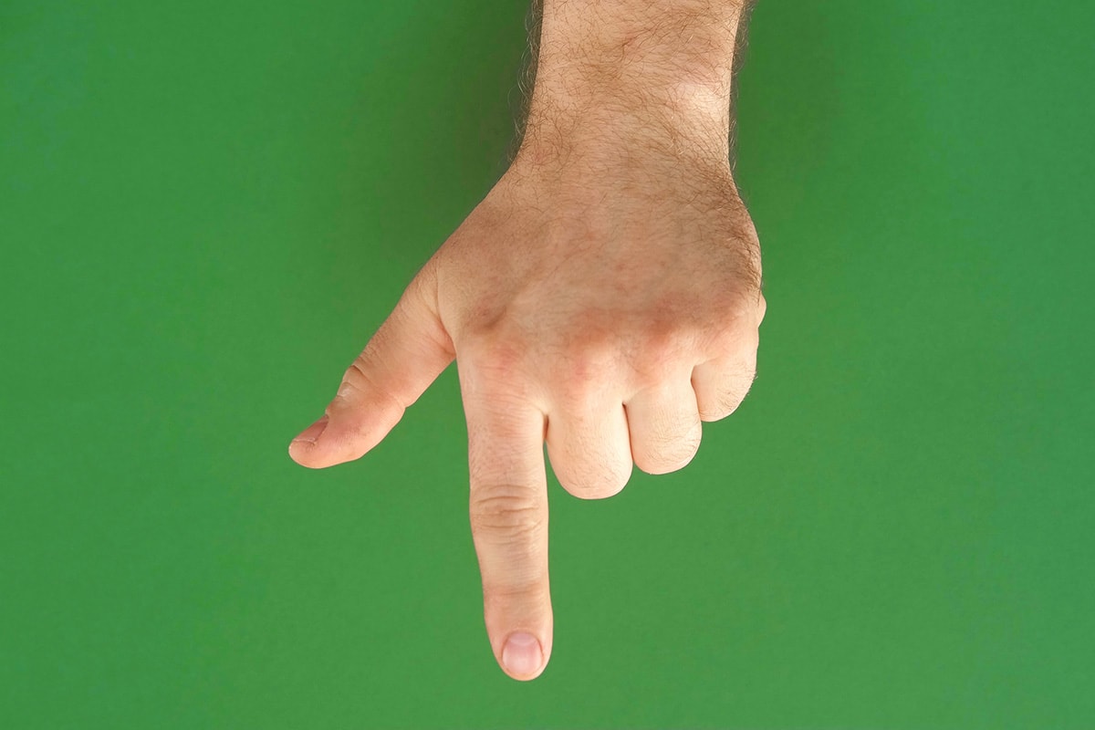 A hand pointing down the page.