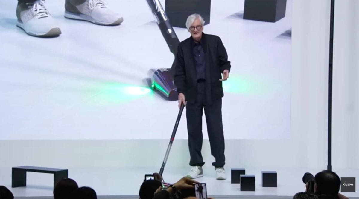 James Dyson presenting the Dyson PencilVac at a product launch event.