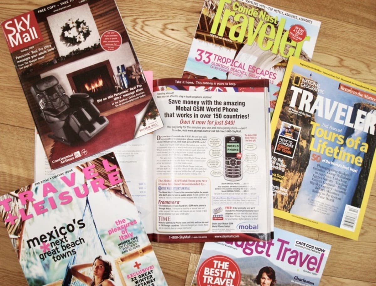 A spread of travel magazines, highlighting an advertisment for Mobal