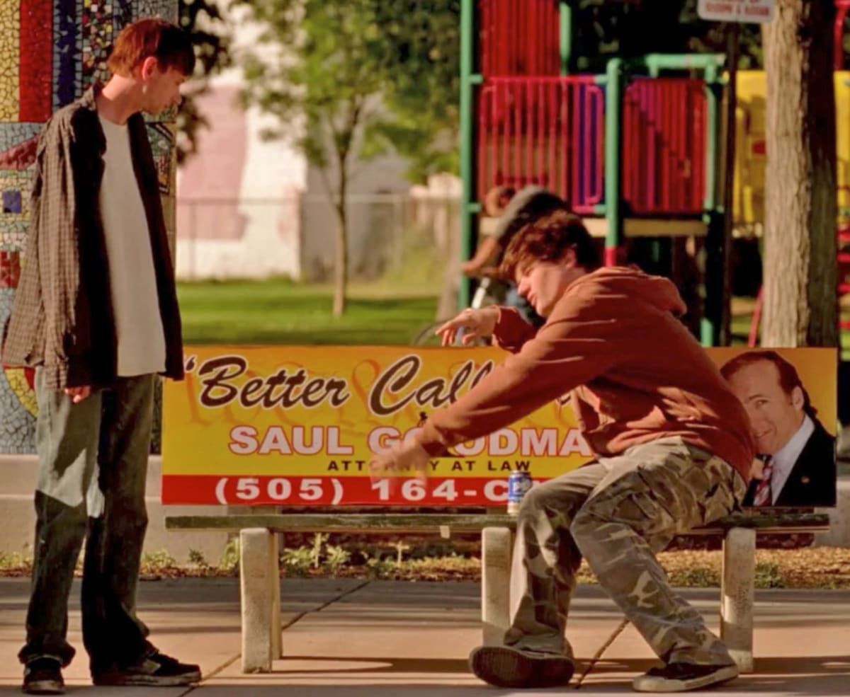 Two criminals discuss commiting a crime on one of Saul’s advertising benches.