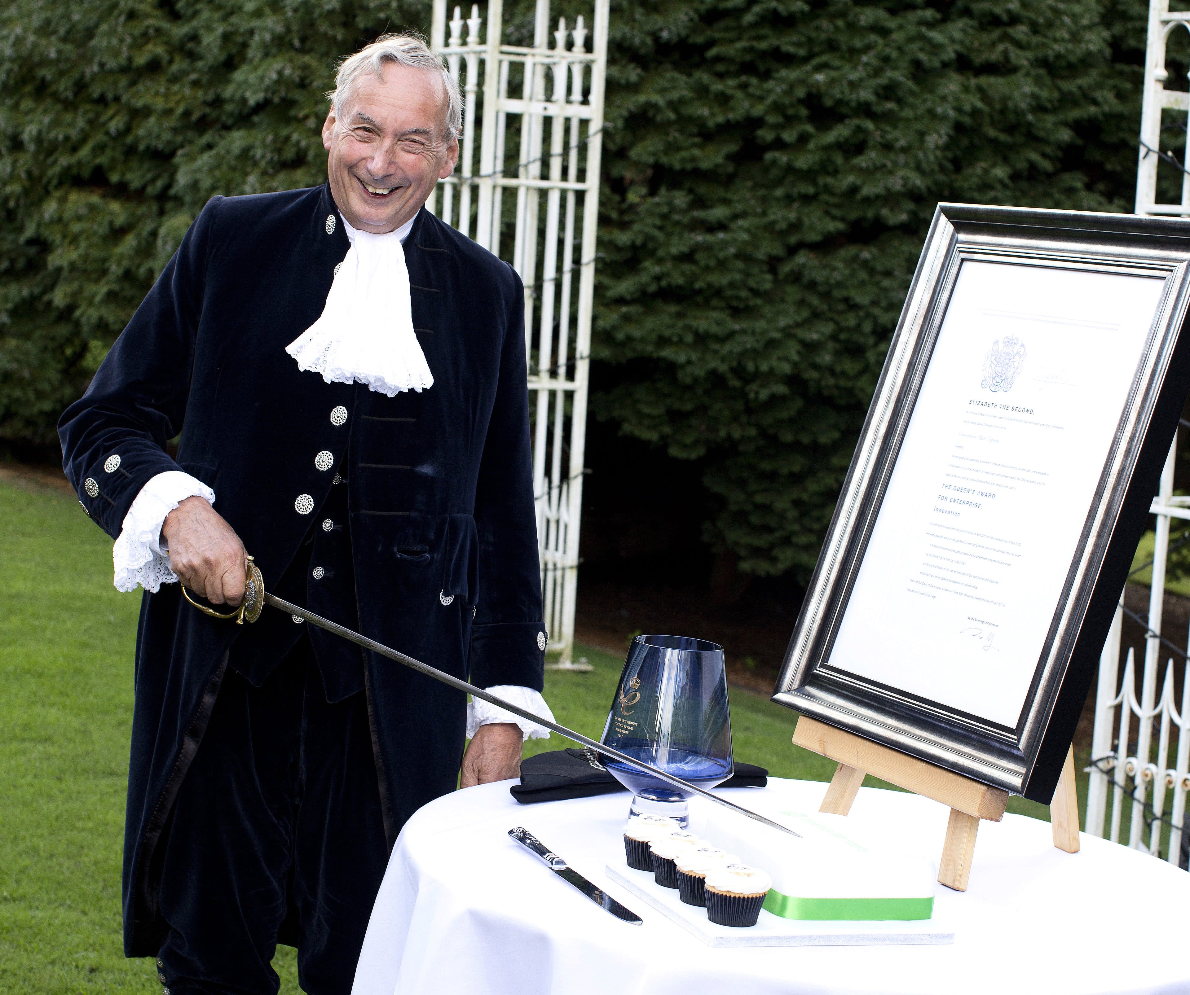 The Sheriff of Stafford cutting the cake with his sword