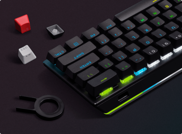 Custom keycaps next to the 60% wireless keyboard.