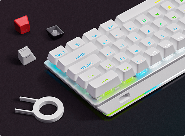 Custom keycaps next to the 60% wireless keyboard.