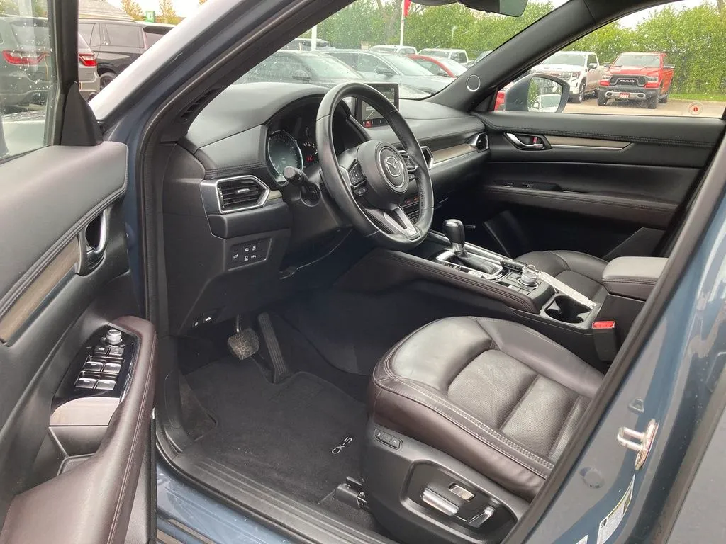 I need a Mazda CX-5, ideally Grand Touring or GS trim, for resale to a small family. Safety features like blind-spot detection and lane assist are highly preferred. Less than 120,000 km.