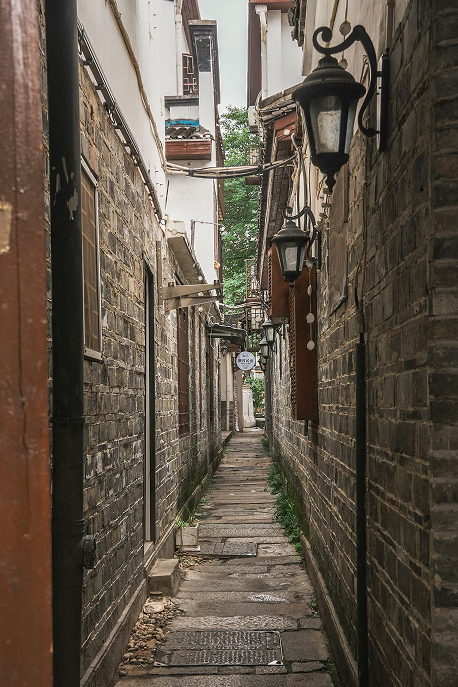 A quiet brick alley before sunrise