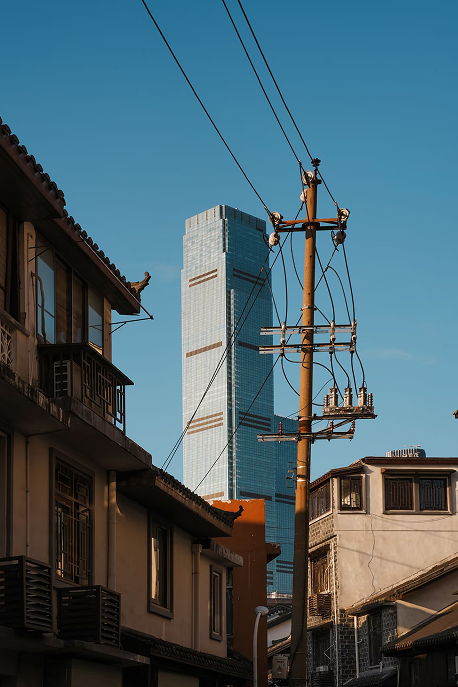 Old houses and a glass tower in one frame