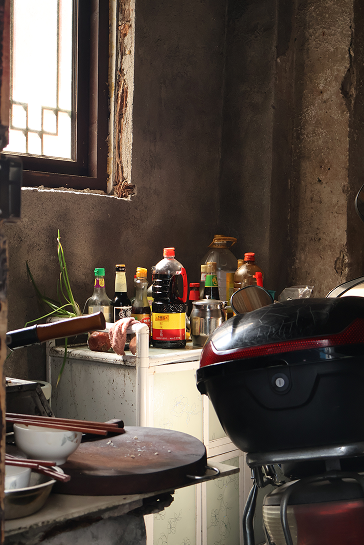 An old kitchen with bottles by the window