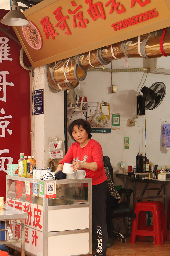 A noodle shop owner at the counter