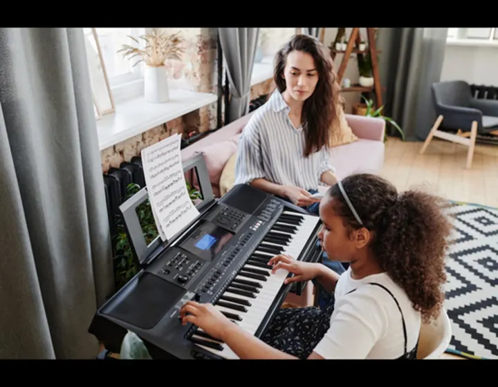  Piano teacher teaching a Girl Play Piano in Portland